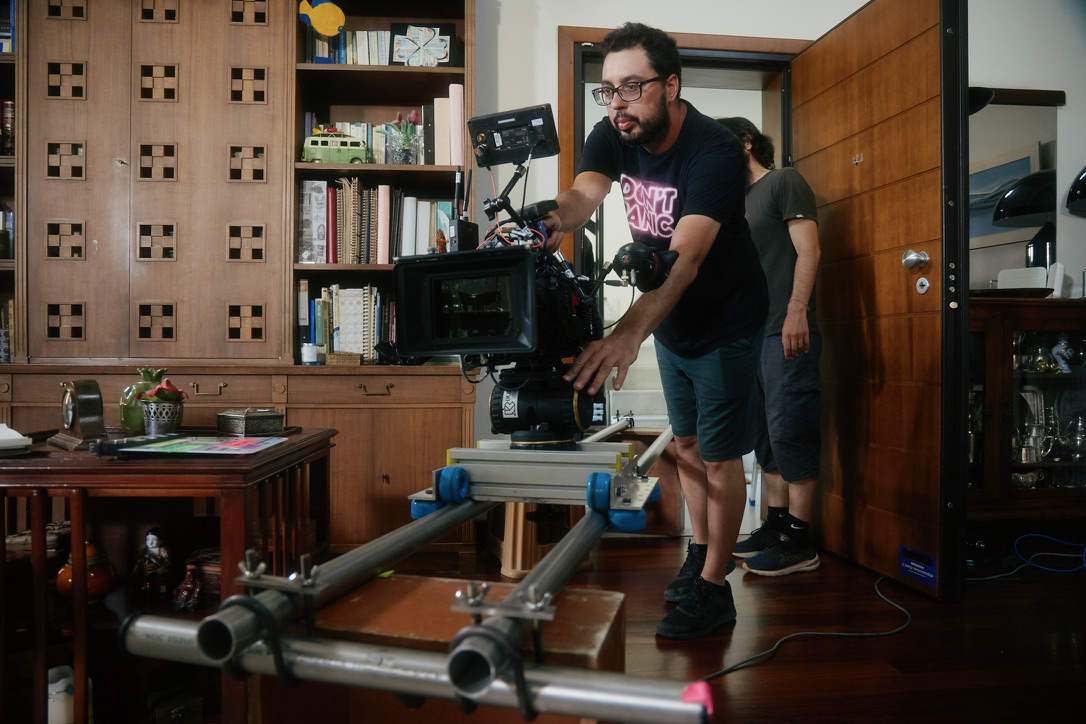Alexandros Kapidakis operating a cinema camera on a dolly on set.