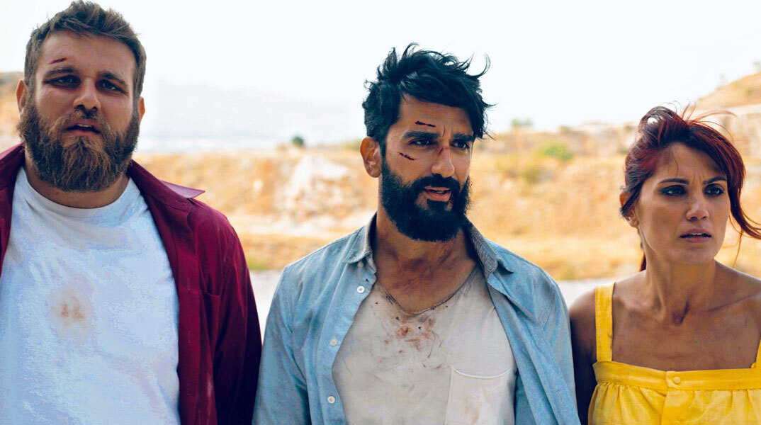 Three bruised characters stand in the bright summer light in Kakes Idees.